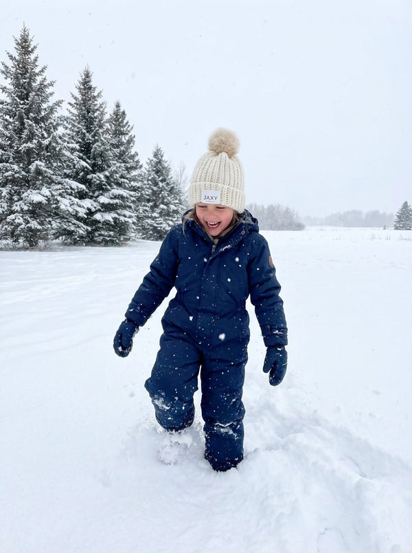 10 year old wearing ivory jaxy beanie in the snow