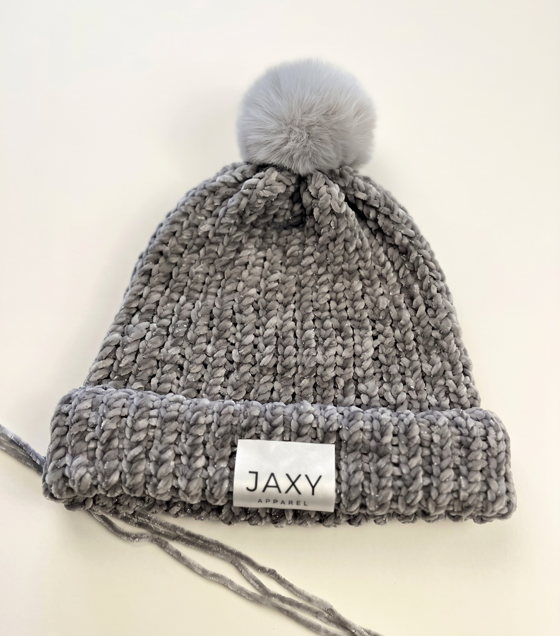 Super soft, refined and quietly luxurious. A plush handmade Jaxy beanie in Silver-Mist with a delicate silver shimmer and matching pom-pom. Made in Australia.